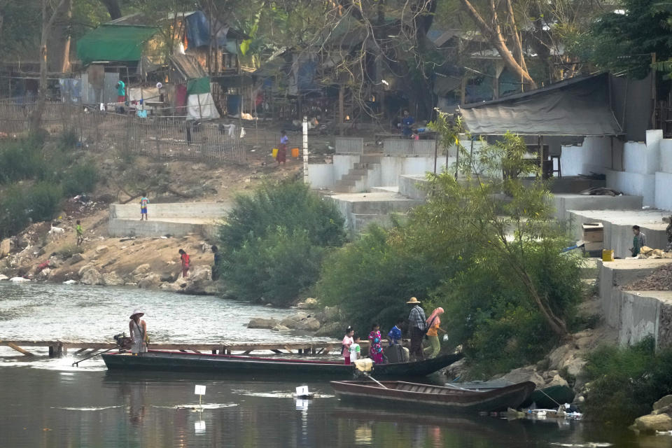 Myanmar resident cross the Moei river on the Thai side, near the 1st Thai-Myanmar Friendship Bridge in Mae Sot in Thailand's Tak province on Friday, April 12, 2024.