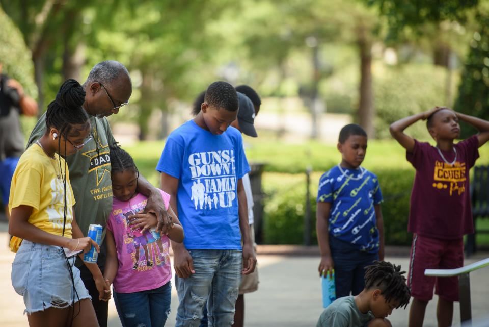 People pray at the Guns Down, Family Up event in front of the Cumberland County Courthouse on Saturday, June 24, 2023.