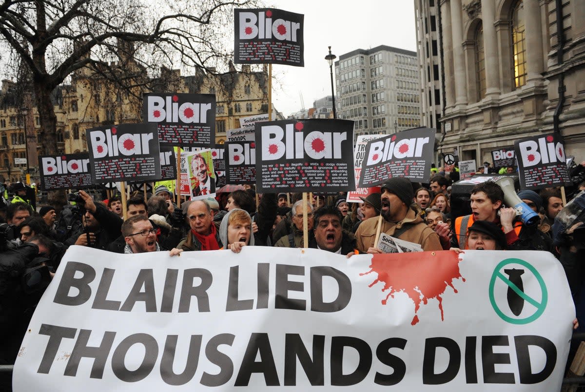 People protest outside where former prime minister Tony Blair was due to give evidence to the Chilcott Inquiry in January 2010 (PA)