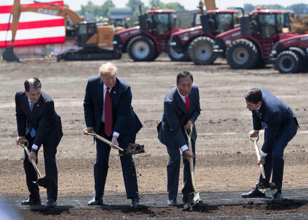 Former President Donald Trump takes part in a 2018 ceremonial groundbreaking for Foxconn's factory in Mount Pleasant, Wis. The project was never built, and on Wednesday President Joe Biden touted a $3.3 billion Microsoft artificial intelligence campus for the same site.