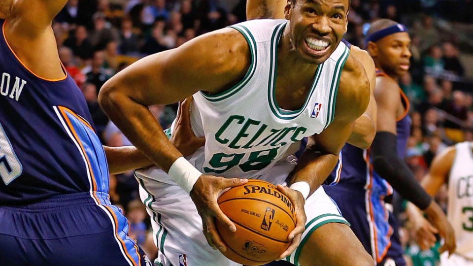 BOSTON, MA – JANUARY 14: Jason Collins #98 of the Boston Celtics splits the defenders underneath the basket in front of Gerald Henderson #9 of the <a class="link " href="https://sports.yahoo.com/nba/teams/charlotte/" data-i13n="sec:content-canvas;subsec:anchor_text;elm:context_link" data-ylk="slk:Charlotte Bobcats;sec:content-canvas;subsec:anchor_text;elm:context_link;itc:0">Charlotte Bobcats</a> during the game on January 14, 2013, at TD Garden in Boston, Massachusetts. (Jared Wickerham/Getty Images)