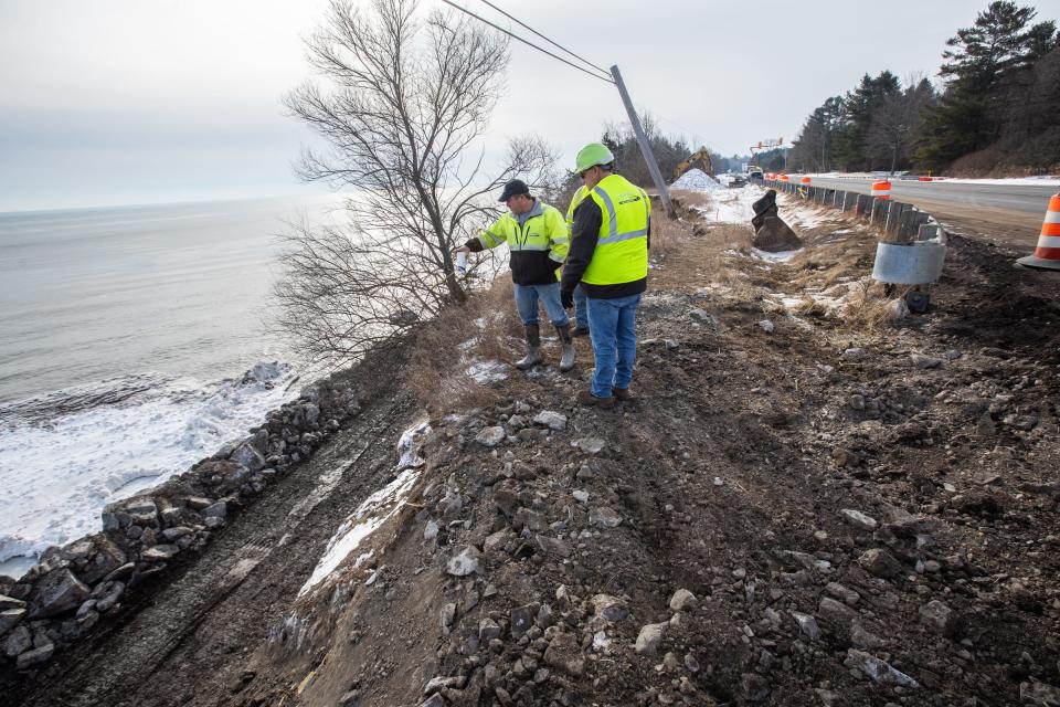 Sanilac Township Road Commission workers discuss next steps to stabilize a section of land off M-25 in Lexington Township, Mich., on Thursday, Jan. 23, that is damaged due to erosion from Lake Huron.