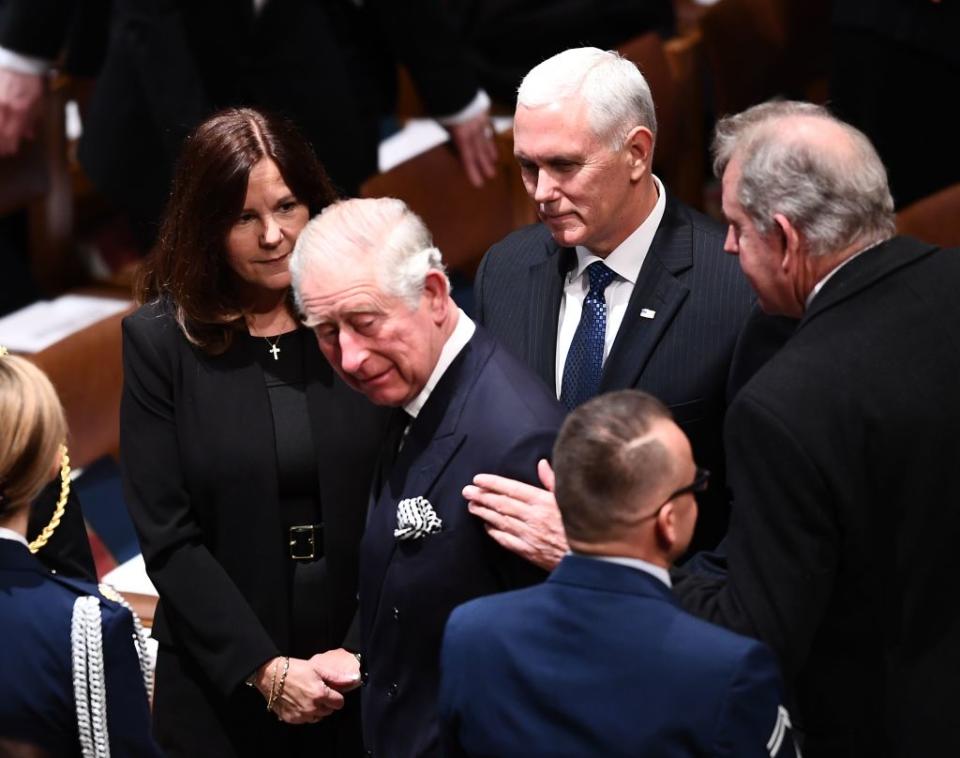 Britain's Prince Charles is greeted by Karen Pence and her husband, U.S. Vice President Mike Pence, as they arrive for the funeral service for former US President George H. W. Bush at the National Cathedral in Washington, DC on December 5, 2018.