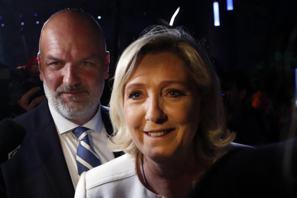 Far-right National Party leader Marine le Pen, escorted by her bodyguard Thierry Legier, leaves after delivering a speech at the campaign headquarters, Sunday, May 26, 2019 in Paris. Le Pen declared victory in the European Parliament election over pro-EU French President Emmanuel Macron. (AP Photo/Thibault Camus)