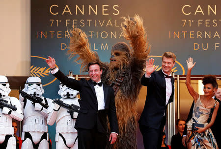 FILE PHOTO: 71st Cannes Film Festival - Screening of the film "Solo: A Star Wars Story" out of competition - Red Carpet Arrivals - Cannes, France May 15, 2018. Producer Simon Emanuel and cast members Joonas Suotamo, Thandie Newton and Chewbacca pose. REUTERS/Stephane Mahe