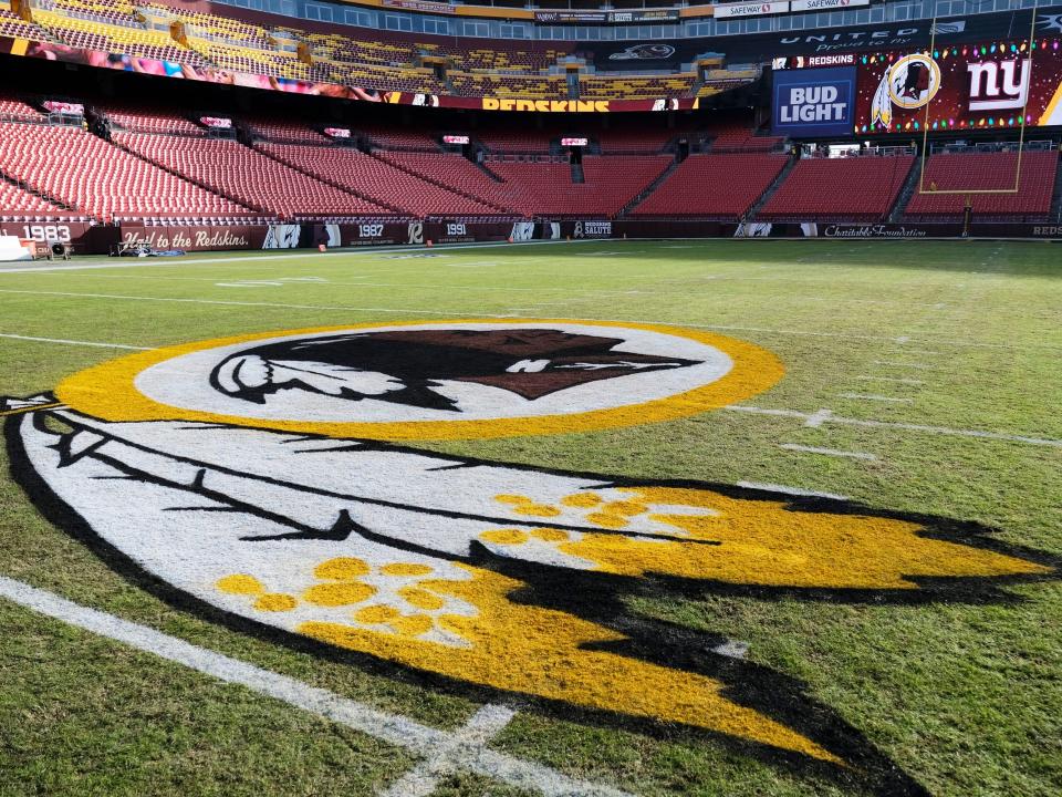 FILE - In this Dec. 22, 2019, file photo, the Washington Redskins logo is seen on FedEx Field prior to an NFL football game between the New York Giants and the Redskins in Landover, Md. Washington state Attorney General Bob Ferguson says Seattle-based Amazon will begin pulling Redskins team merchandise from its online marketplace. Ferguson urged the online giant to remove such merchandise it because of growing calls for the team to change what he called their use of a racial slur in the name. (AP Photo/Mark Tenally, File)