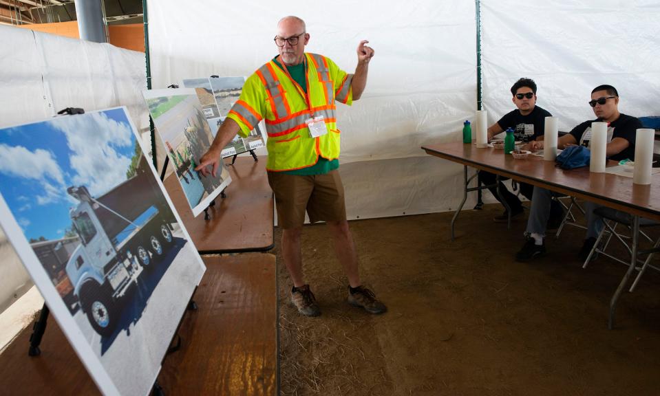 Florida Department of Transportation employee Glenn Cook teaches students about asphalt road paving during the third annual construction career day in Santa Rosa County on Wednesday, April 26, 2023. Students from Santa Rosa, Escambia and Okaloosa counties participated in the event.