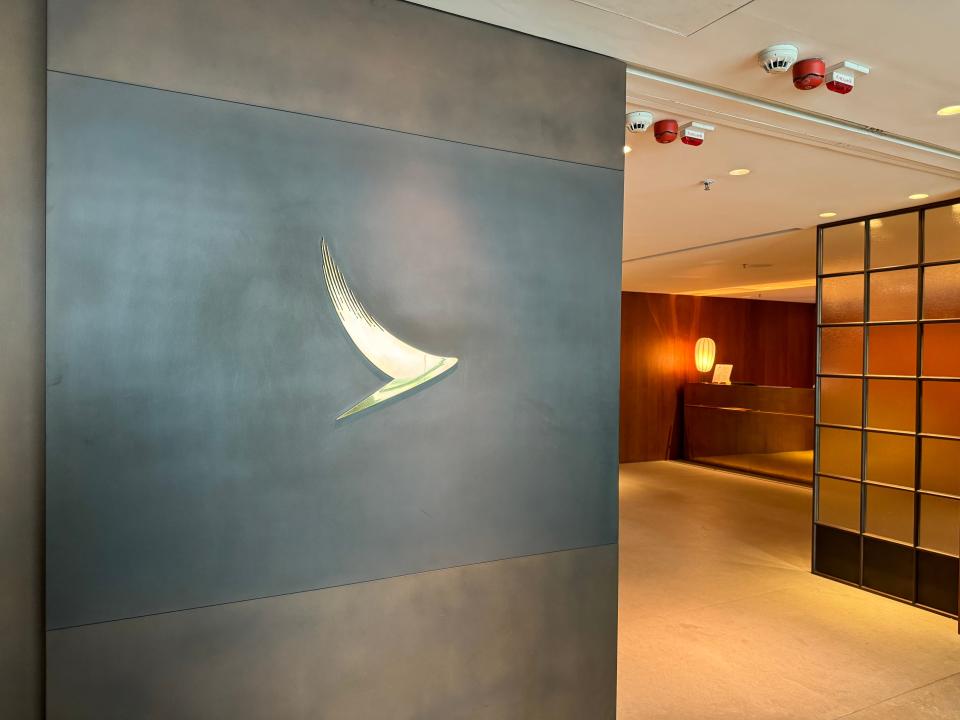 The sleek entrance to Cathay Pacific's The Pier, a first- class lounge at Hong Kong International Airport, is marked with a Cathay Pacific logo.