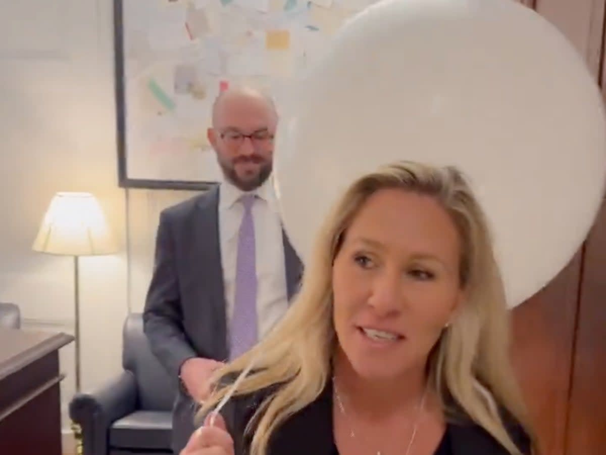 Representative Marjorie Taylor Greene carrying a white balloon she intends to bring with her to the State of the Union address (screengrab/Twitter/Marjorie Taylor Greene)