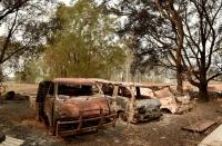 The burnt-out remains of cars and property belonging to Art Murphy and his wife Shirley are seen following bushfires in Old Bar, 350km north of Sydney on November 11, 2019. A state of emergency on November 11 was declared and residents in the Sydney area were warned of "catastrophic" fire danger as Australia girded for a fresh wave of deadly bushfires that have ravaged the drought-stricken east of the country. (Photo by PETER PARKS / AFP) (Photo by PETER PARKS/AFP via Getty Images)