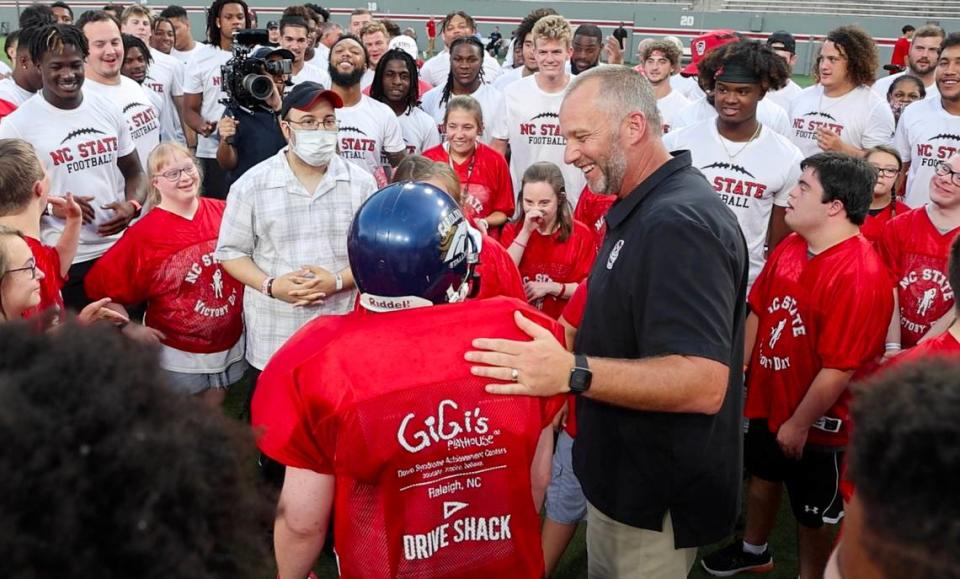 N.C. State head football coach Dave Doeren gathers everybody together during “Victory Day” at Carter-Finley Stadium in Raleigh, N.C., Friday, August 5, 2022. On Victory Day, the Wolfpack partner with GiGi’s Playhouse to give cognitively and physically impaired children a chance to play football alongside the Pack.