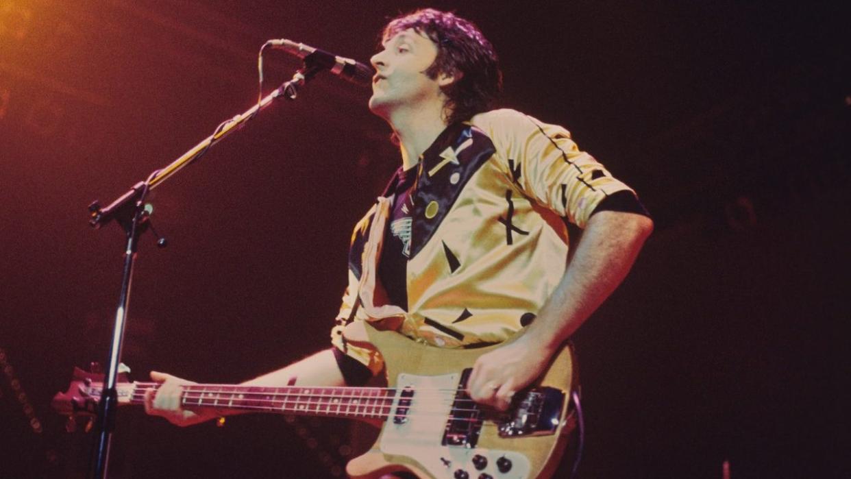  Paul McCartney performs live on stage with Wings at Ahoy on 25th March 1976 in Rotterdam, Netherlands. He plays a Rickenbacker 4001S bass guitar 