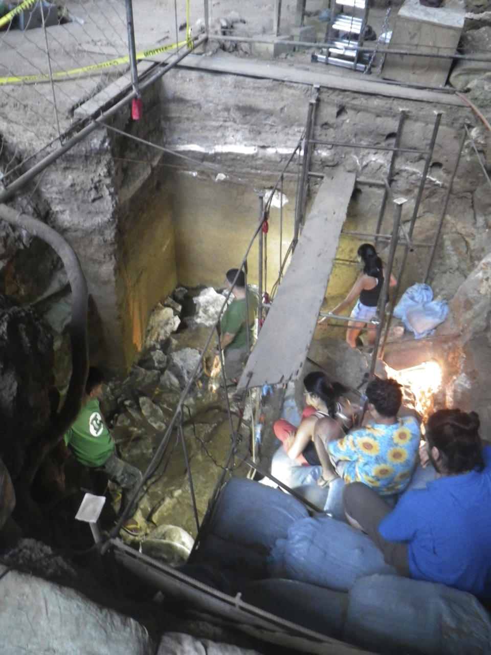 In this June 30, 2015 handout photo provided by Eusebio Dizon, foreign and Filipino archeologists work inside Callao cave in Cagayan province, northern Philippines where they recovered fossil bones and teeth belonging to a new human species they called Homo Luzonensis. Archaeologists who discovered fossil bones and teeth of a previously unknown human species that thrived more than 50,000 years ago in the northern Philippines say they plan more diggings and better protection of the popular limestone cave complex where the remains were unearthed. (Eusebio Dizon via AP)