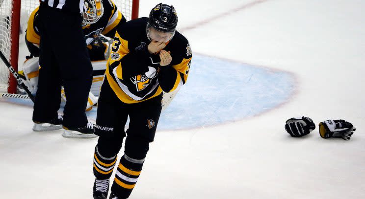 Pittsburgh Penguins’ Olli Maatta grabs his nose after being hit there by a Nashville Predators’ stick during the third period in Game 5. (Gene J. Puskar/AP)