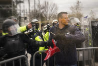 FILE - In this Jan. 6, 2021, file photo, rioters try to break through a police barrier at the Capitol in Washington. (AP Photo/John Minchillo, File)