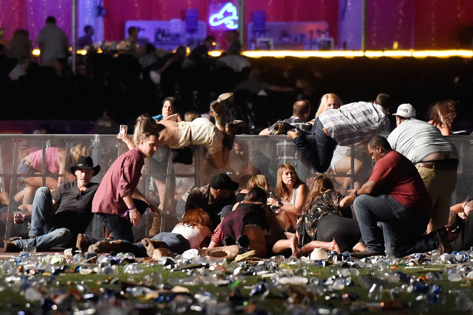 <p>OCT. 1, 2017 – People scramble for shelter at the Route 91 Harvest country music festival after apparent gun fire was heard in Las Vegas, Nevada. Stephen Paddock, a 64-year-old resident of Mesquite, Nevada, suspected of killing at least 59 people and injuring at least 527, shot himself shortly after the attack. The motive is still unknown. (Photo: David Becker/Getty Images) </p>