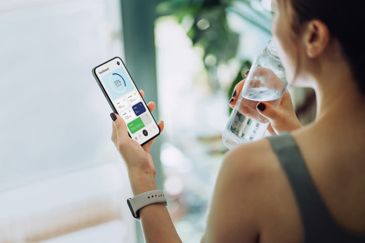 Woman using fitness app on smartphone