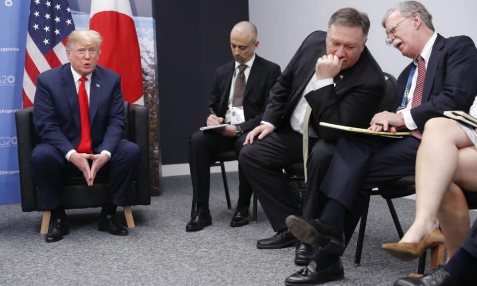 John Bolton, far right, talks to secretary of state Mike Pompeo as Donald Trump looks on.