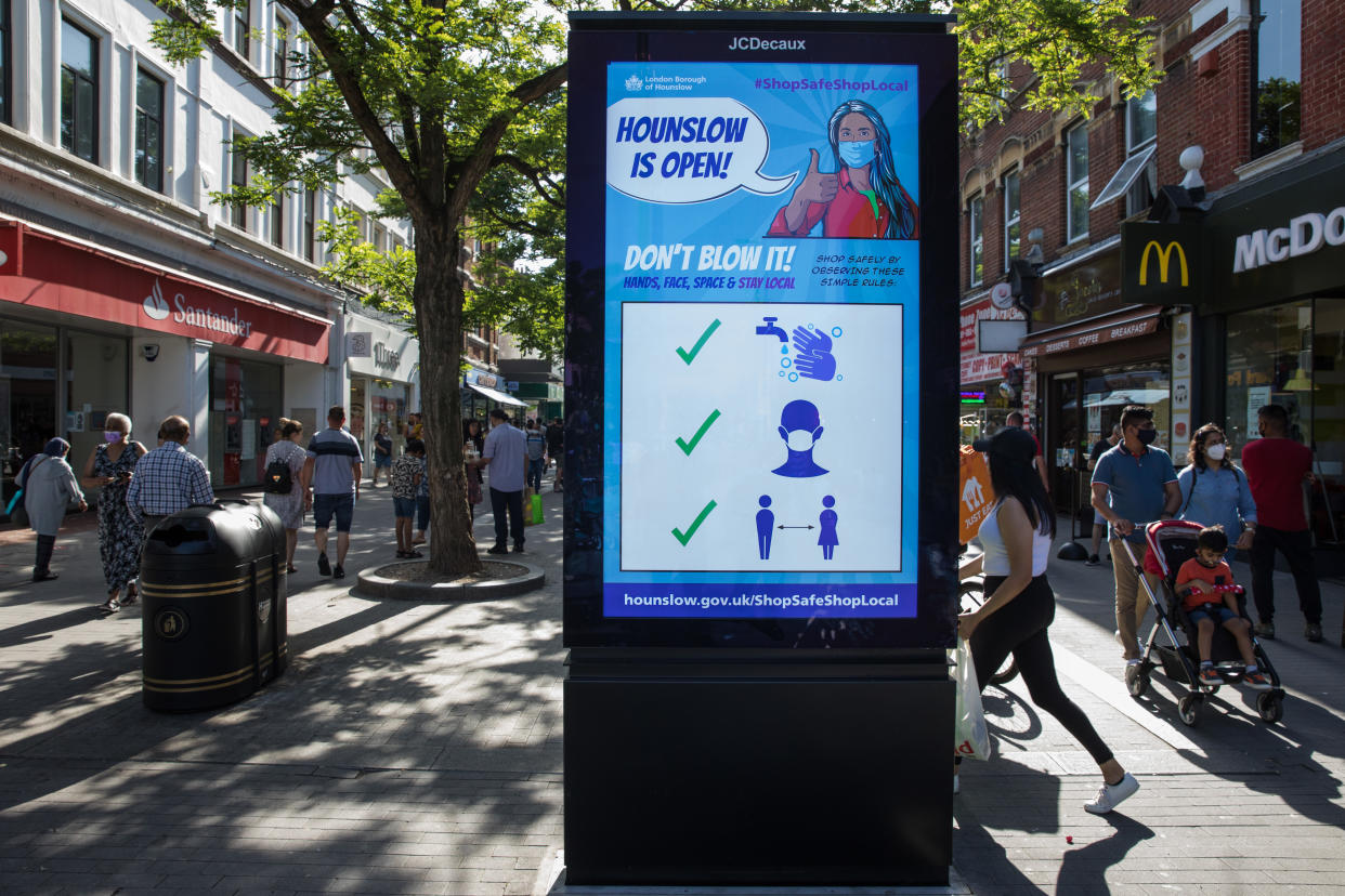 Members of the public pass a London Borough of Hounslow Covid-19 public information display urging residents to take precautions to minimise the spread of the coronavirus amid rising concern regarding the Delta variant on 17th July 2021 in Hounslow, United Kingdom. The UK government is currently still expected to lift almost all restrictions on social contact on 19th July, known as 'Freedom Day', but the current wave driven by the Delta variant is not expected to peak until mid-August. (photo by Mark Kerrison/In Pictures via Getty Images)