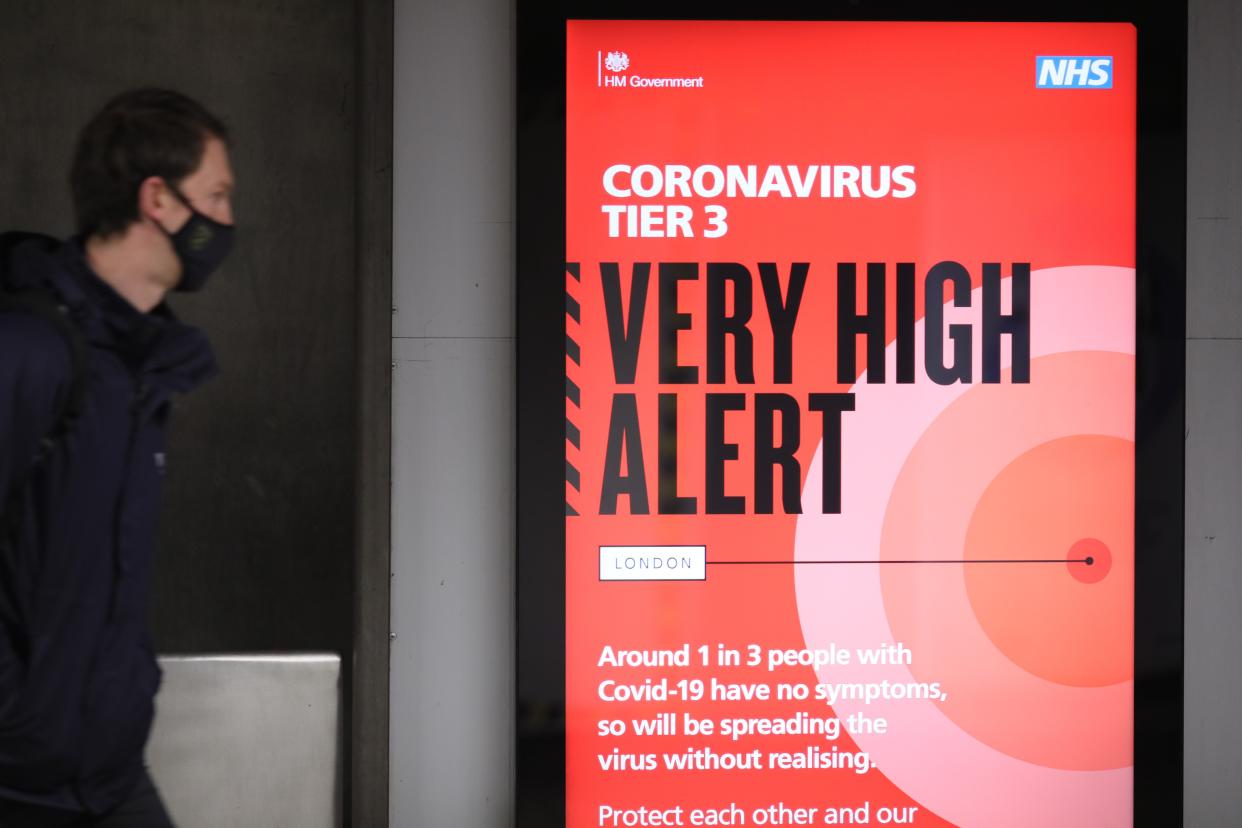 LONDON, Dec. 15, 2020 -- A person walks past a sign at Waterloo Underground Station in London, Britain, on Dec. 15, 2020. London moved into Tier Three, the highest level in England's local coronavirus restriction tier system, from midnight on Wednesday. (Photo by Tim Ireland/Xinhua via Getty) (Xinhua/Tim Ireland via Getty Images)