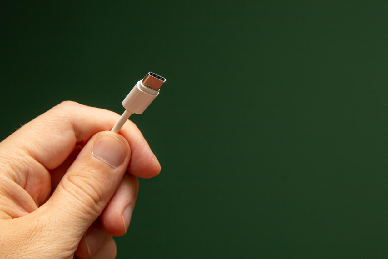 close up of hand holding usb-c cord