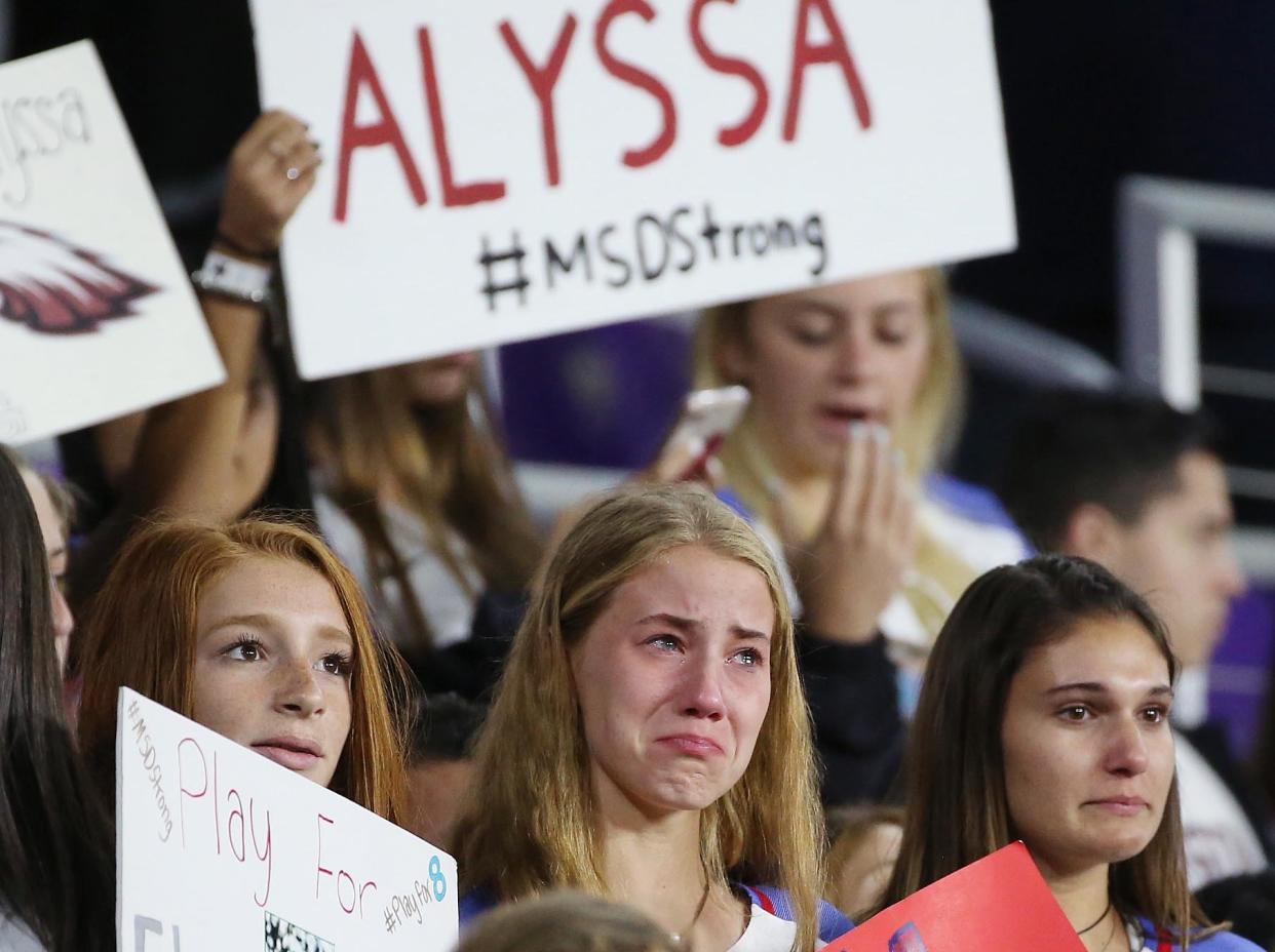 Soccer players and other students from Marjory Stoneman Douglas High School in Parkland, Florida, hold signs and wear the jersey of their former teammate, Alyssa Alhadeff, who was killed in the massacre at the school on Feb. 14. The students remembered Alyssa before the start of&nbsp;a She Believes Cup women's soccer match on March 7 in Orlando, Florida.&nbsp; (Photo: Stephen M. Dowell/Orlando Sentinel via Getty Images)
