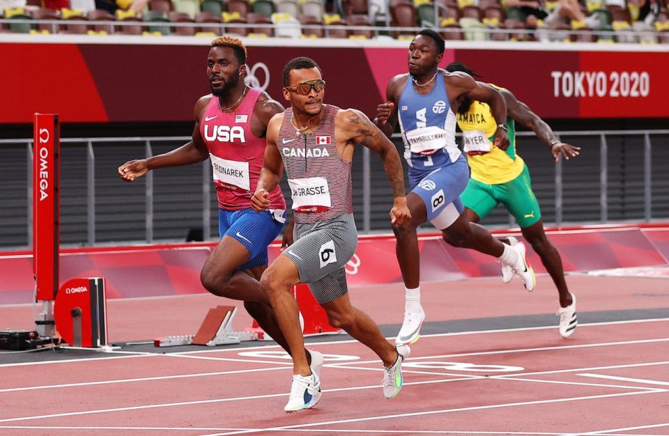 Canada's Andre De Grasse is shown crossing the finish line for gold in the men's 200-metre final at the Tokyo 2020 Olympic Games in August 2021 in Tokyo. Under a plan announced by World Athletics on Wednesday, a similar win at the Paris Olympics would net the gold medallist a $50,000 US reward.