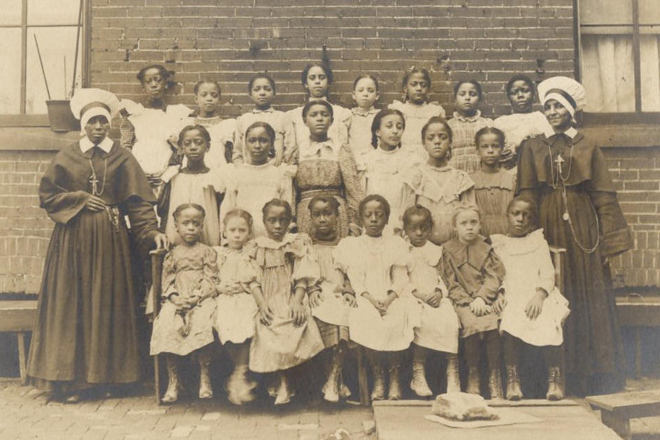 This circa 1875 photo provided by the Oblate Sisters of Providence shows Sisters Mildred Thomas and Regina Frazier with students and orphans at Saint Frances School for Girls in Baltimore, Md. Mother Mary Lange, who co-founded the Oblate Sisters of Providence in Baltimore in 1829, is among six Black Catholic Americans formally placed in the canonization process that could lead to sainthood. (Oblate Sisters of Providence via AP)