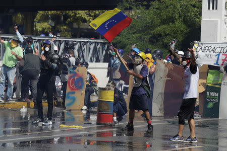 A demonstrator waves a Venezuelan flag during a rally against Venezuela's President Nicolas Maduro in Caracas, Venezuela May 26, 2017. REUTERS/Marco Bello