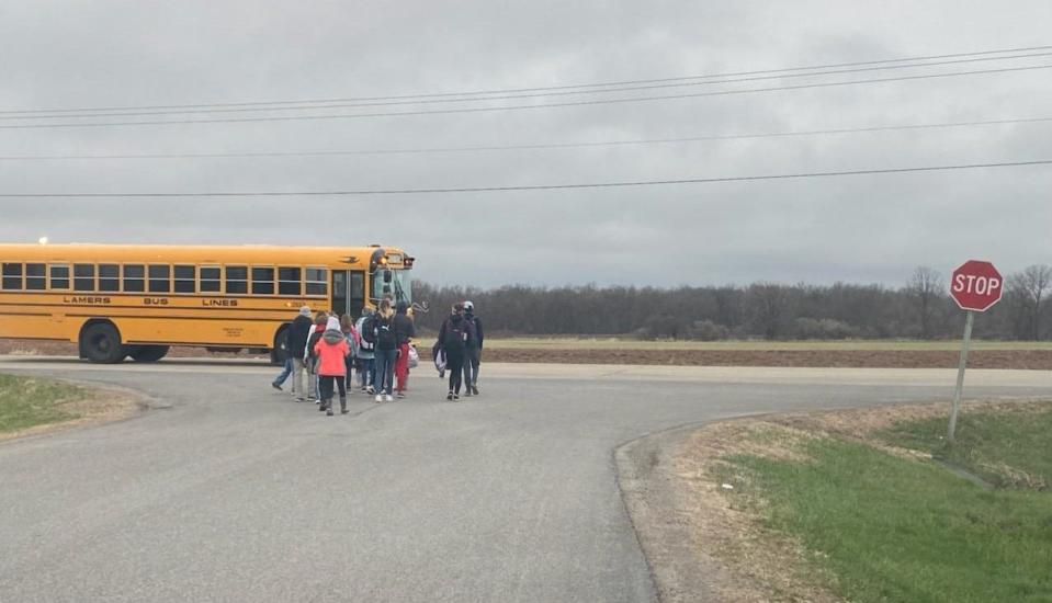 Students wait to get on the bus in the morning at the corner of Gray Wolf Drive and County S between Oshkosh and Winneconne.