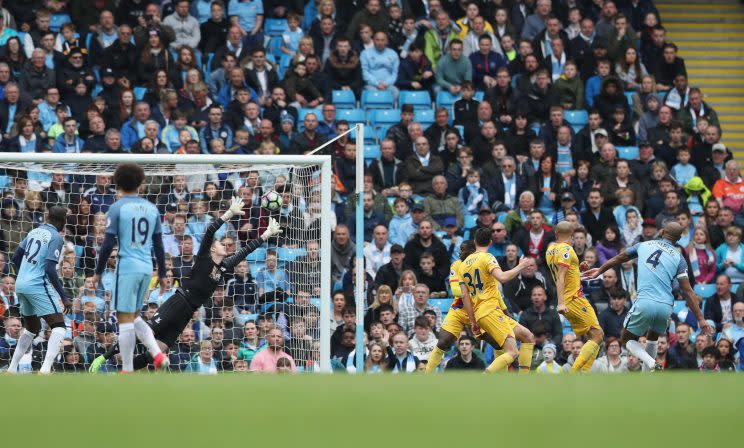 Three Crystal Palace players watch on as Kompany makes it two