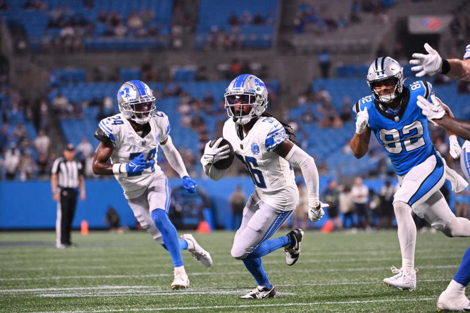 Aug 25, 2023; Charlotte, North Carolina, USA; Detroit Lions cornerback Steven Gilmore (36) intercepts the ball and returns it for a touchdown as Carolina Panthers defensive tackle <a class="link " href="https://sports.yahoo.com/nfl/players/32973" data-i13n="sec:content-canvas;subsec:anchor_text;elm:context_link" data-ylk="slk:Raequan Williams;sec:content-canvas;subsec:anchor_text;elm:context_link;itc:0">Raequan Williams</a> (92) defends in the fourth quarter at Bank of America Stadium. Mandatory Credit: Bob Donnan-USA TODAY Sports