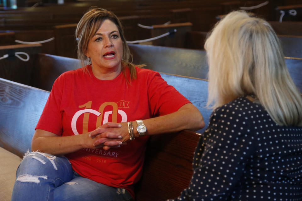 Teresa Stanfield, left, the Oklahoma field director with Virginia-based Prison Fellowship, talks with Teresa Peden, pastor of recovery at Crossing Community Church, Tuesday, Aug. 11, 2020, at the church in Oklahoma City. Normally, Stanfield is behind bars, talking with inmates about how she changed the course of her troubled life. The coronavirus has forced her out of prisons. For the time being, Stanfield is videotaping her message. (AP Photo/Sue Ogrocki)