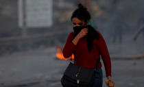 A Palestinian woman reacts during clashes with Israeli troops near the Jewish settlement of Beit El, near Ramallah, in the Israeli-occupied West Bank December 13, 2018. REUTERS/Mohamad Torokman