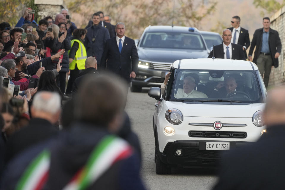 Pope Francis is cheered by faithful upon his arrival in San Carlo, near Asti, Italy, Saturday, Nov. 19, 2022. The Pontiff returned to his father's birthplace in northern Italy on Saturday for the first time since ascending the papacy to celebrate the 90th birthday of a second cousin who long knew him as simply "Giorgio." (AP Photo/Gregorio Borgia)