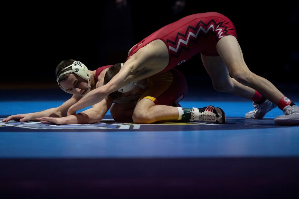 Charlie LaRocca of Center Grove and Ty Henderson of Evansville Mater Dei compete in the 120-pound championship match of the 2024 IHSAA State Wrestling tournament at Ford Center in Evansville, Ind., Saturday, Feb. 17, 2024.