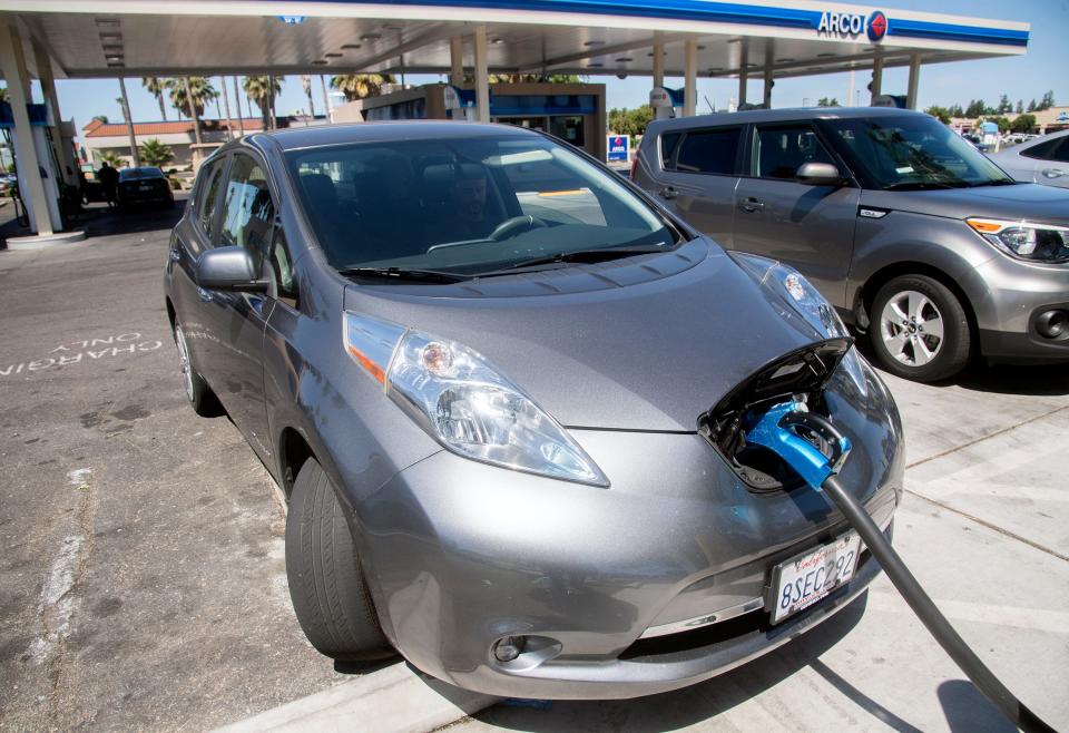 A Nissan Leaf electric vehicle charges at a ChargePoint charging station Wednesday at the Arco AM/PM gas station on March and West lanes in Stockton.