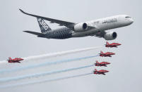 An Airbus A350 aircraft flies in formation with Britain's Red Arrows flying display team at the Farnborough International Airshow in Farnborough, Britain July 15, 2016. REUTERS/Peter Nicholls