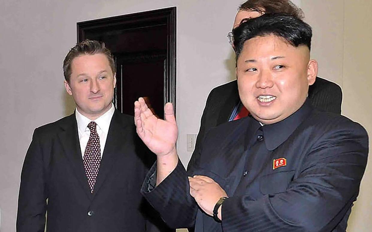 North Korean leader Kim Jong-un speaks with former US basketball star Dennis Rodman (not in picture) as Michael Spavor (left) listens at Pyongyang Gymnasium in Pyongyang - AFP