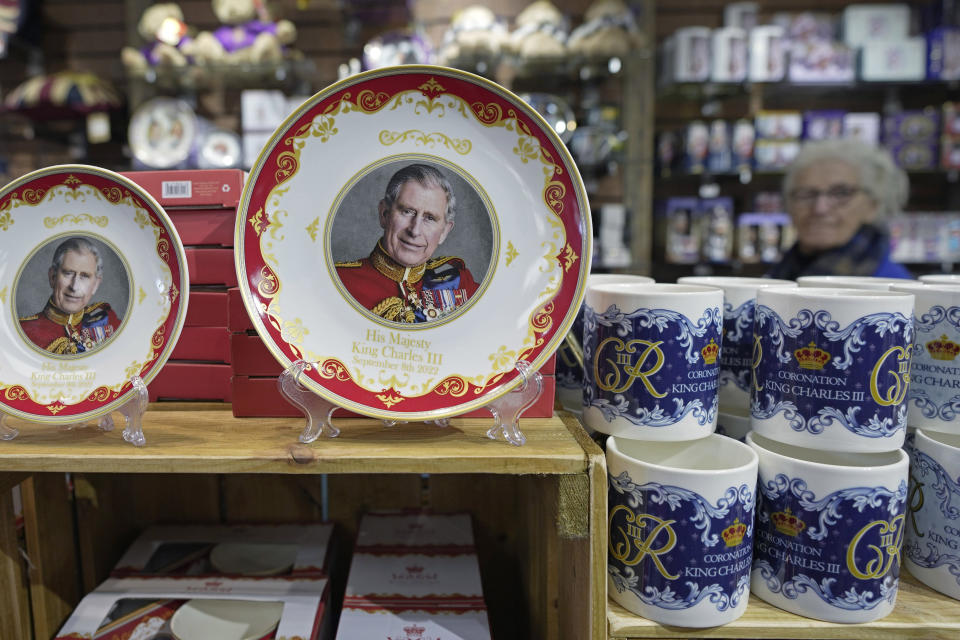 FILE - Coronation plates and mugs are displayed for sale in a gift shop in London, Monday, April 24, 2023. Fans looking to remember the historic event can find everything from fine china to souvenir coins or even cardboard masks of Charles and Camilla. Coronation themed beers, biscuits and chocolates are likely to be quickly forgotten. (AP Photo/Kin Cheung, File)