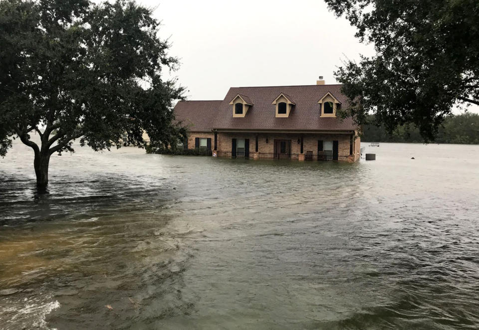 In this photo provided by the Chambers County Sheriff's Office, floodwaters surround a home, Thursday, Sept 19, 2019, in Winnie, Texas. The area has experienced heavy flooding due to Tropical Depression Imelda. (Brian Hawthorne/Chambers County Sheriff's Office via AP)