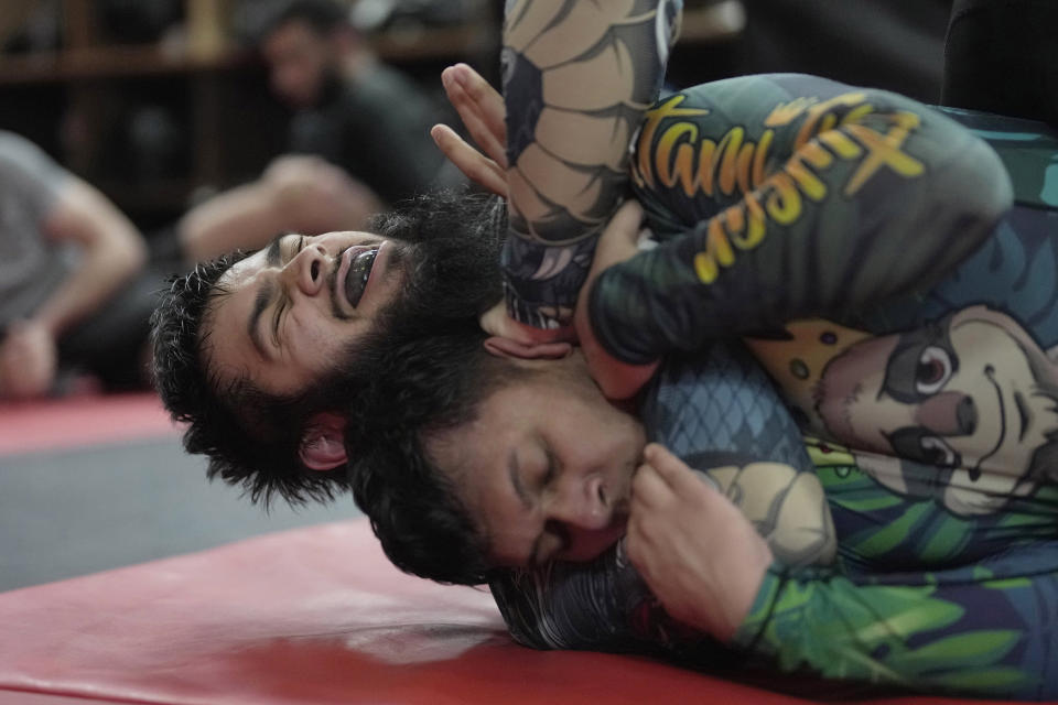 Students practice mixed martial arts moves at Diesel Gym in the Docklands area of East London, Monday, March 25, 2024. The special sessions run by the nonprofit SCK Fitness are held at 10 p.m. during the Muslim holy month of Ramadan to accommodate dawn-to-dusk fasting. (AP Photo/Kin Cheung)