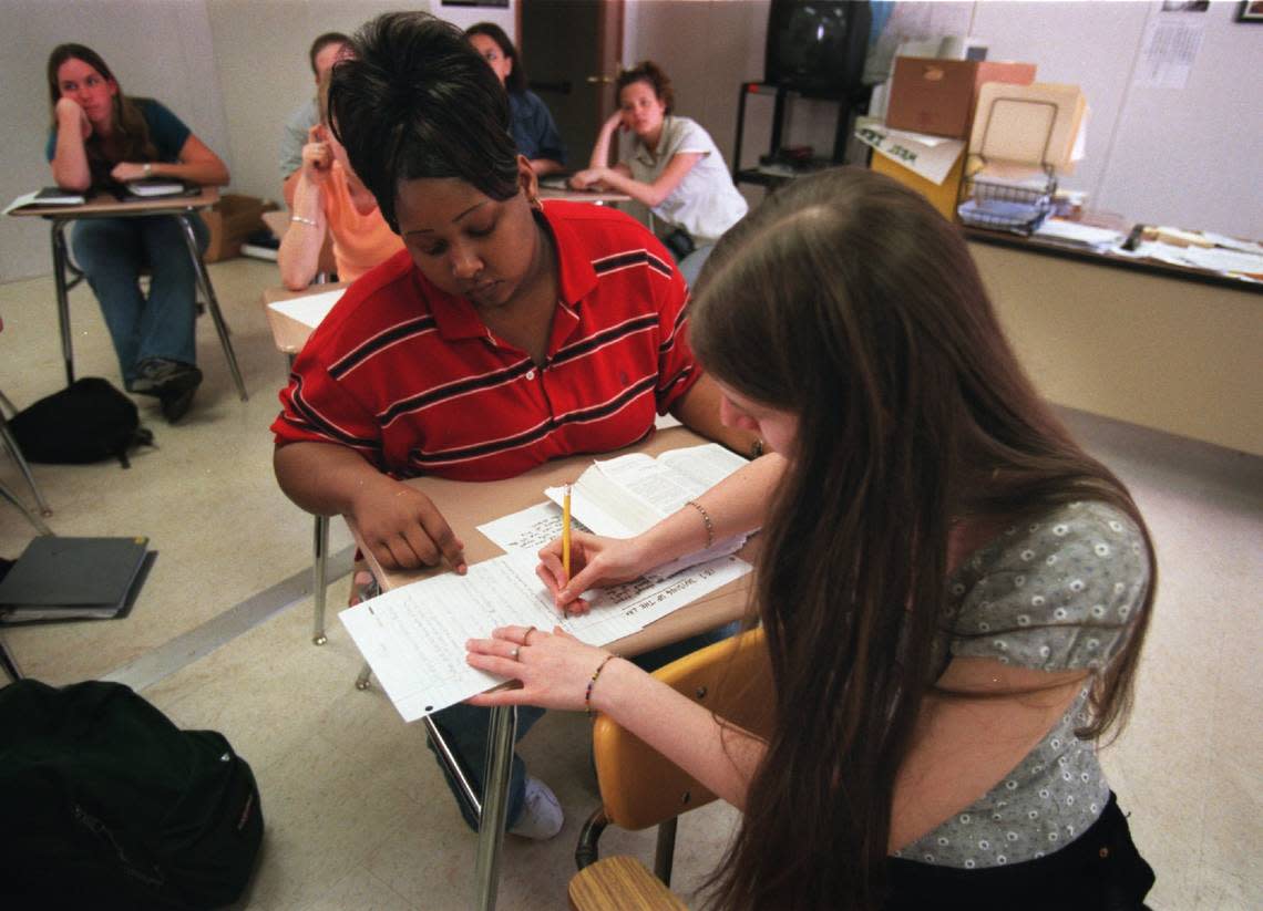 West Iredell High School students Tasha Stokes and Shasta Snyder review questions for an upcoming test on the Book of Joshua during their elective Bible class in this 2001 file photo.