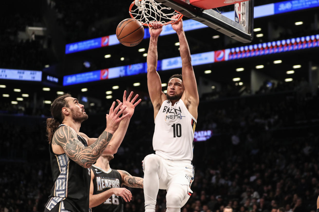 Nov 20, 2022; Brooklyn, New York, USA;  Brooklyn Nets guard Ben Simmons (10) dunks on Memphis Grizzlies center Steven Adams (4) in the third quarter at Barclays Center. Mandatory Credit: Wendell Cruz-USA TODAY Sports