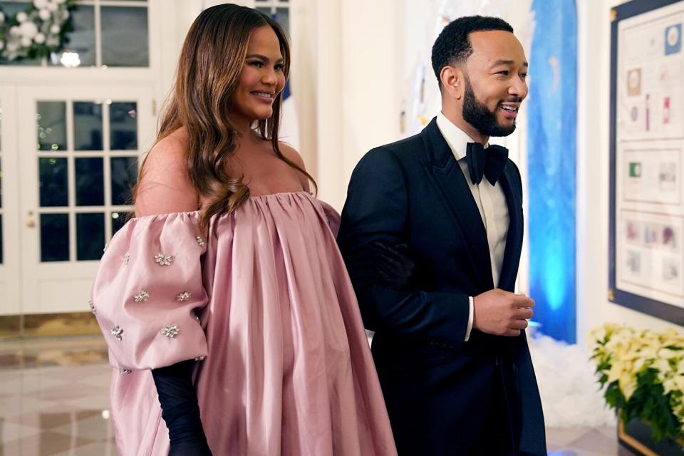 WASHINGTON, DC - DECEMBER 01: John Legend and Chrissy Teigen arrive for the White House state dinner for French President Emmanuel Macron at the White House on December 1, 2022 in Washington, DC. The official state visit is the first of the Biden administration. (Photo by Nathan Howard/Getty Images)