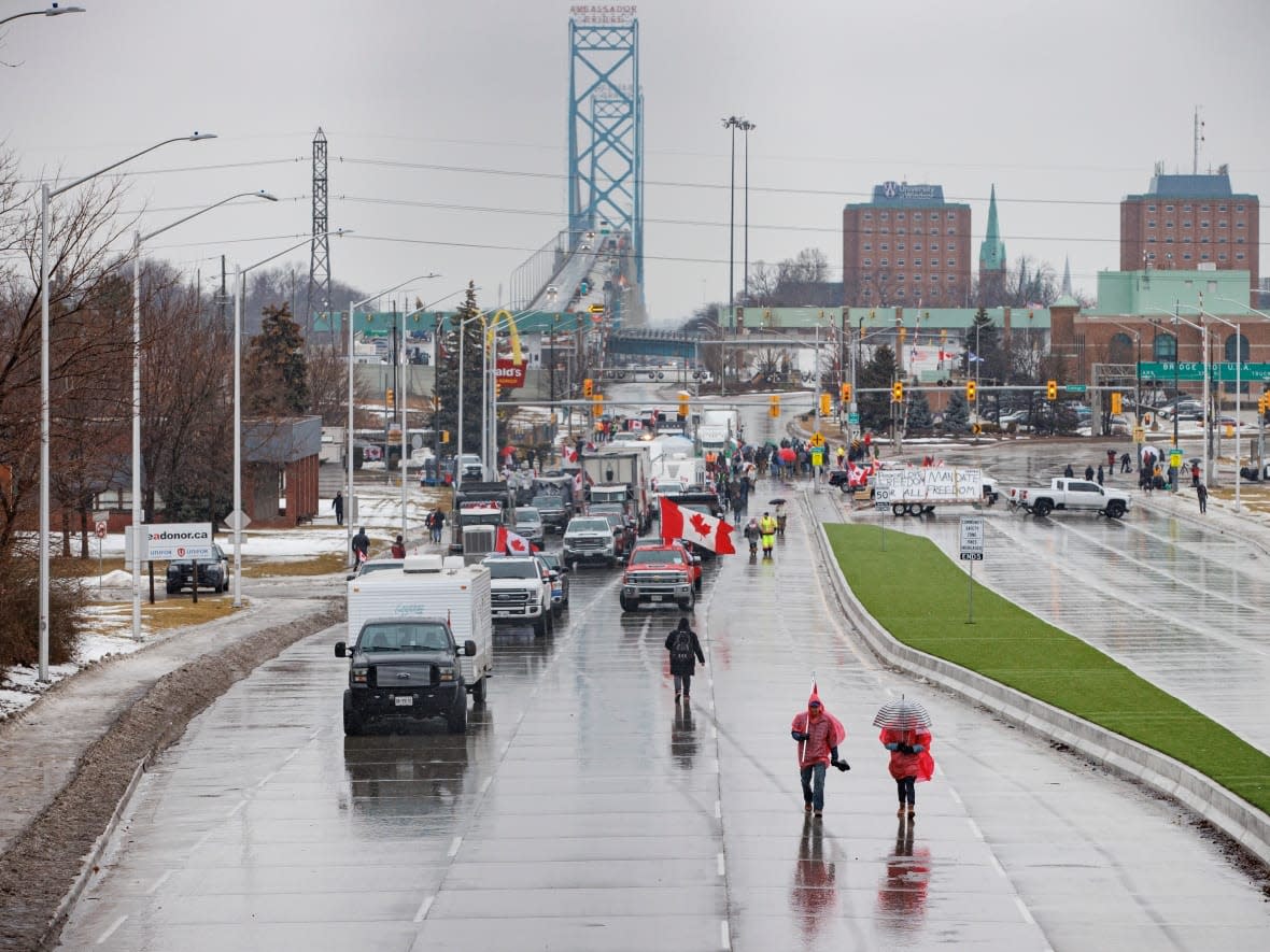 Protesters against pandemic restrictions maintain a blockade of the Ambassador Bridge border crossing, in Windsor, Ont., in this Feb. 11 file photo. On Thursday, Ottawa announced up to $6.9 million in federal support to the City of Windsor for costs incurred during the blockade.  (Evan Mitsui/CBC - image credit)