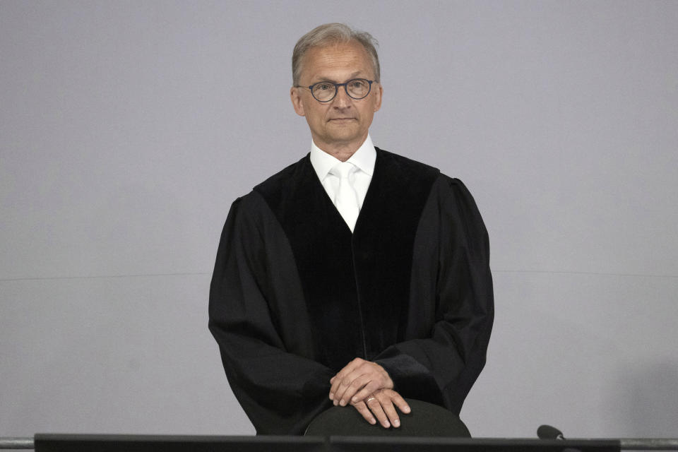 Presiding judge Jürgen Bonk arrives to open a trial against the alleged leaders of a suspected German far-right coup plot, in the Sossenheim branch of the Frankfurt Higher Regional Court, in Frankfurt, Germany, Tuesday, May 21, 2024. The alleged leaders of a suspected far-right plot to topple the German government went on trial on Tuesday, opening the most prominent proceedings in a case that shocked the country in late 2022. Nine defendants faced judges at a special warehouse-like courthouse built on the outskirts of Frankfurt to accommodate the large number of defendants, lawyers and media dealing with the case. (Boris Roessler/Pool Photo via AP)