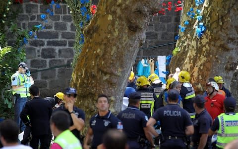 Emergency workers at the scene of the disaster on Tuesday afternoon - Credit: HOMEM DE GOUVEIA/EPA