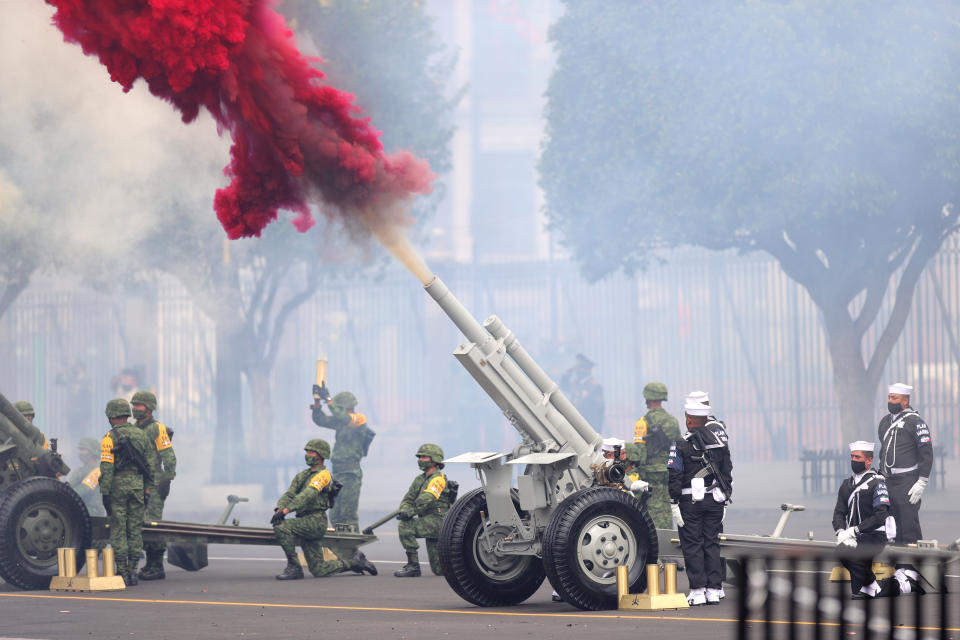 VARIOUS CITIES, MEXICO - SEPTEMBER 16: Soldiers fire a ceremonial artillery salute during the Independence Day military parade at Zocalo Square on September 16, 2020 in Various Cities, Mexico. This year El Zocalo remains closed for general public due to coronavirus restrictions. Every September 16 Mexico celebrates the beginning of the revolution uprising of 1810. (Photo by Hector Vivas/Getty Images)