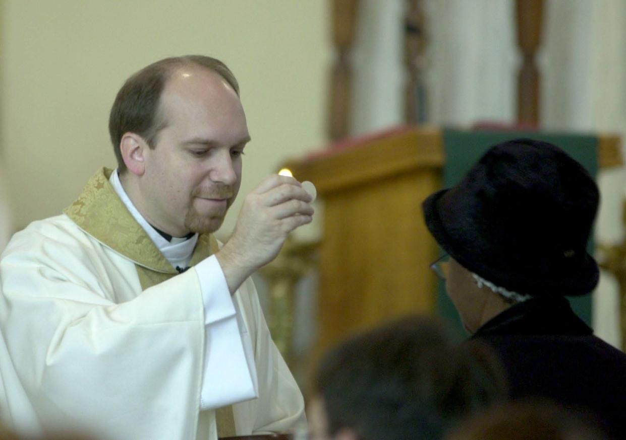 The Rev. Michael Zacharias conducts Mass at St. Peter's Catholic Church in Mansfield in 2014.